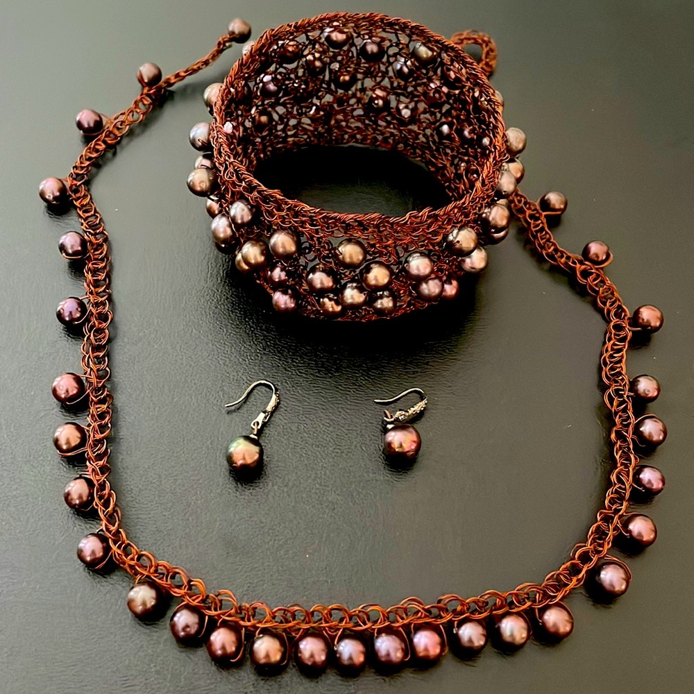 Set of braclet , ring , earing and necklace Handmade in chocolate pearls .